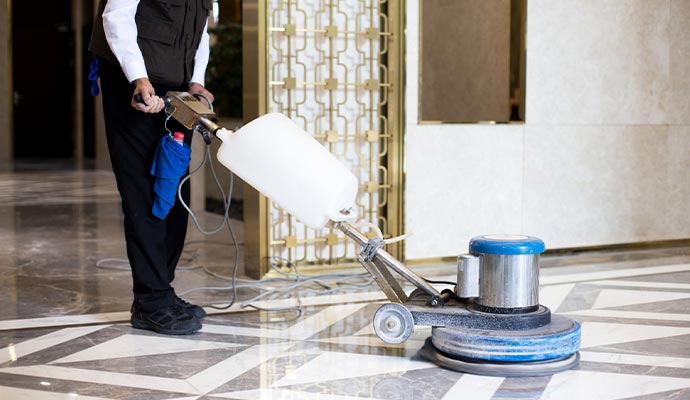 man wear uniform floor cleaning in office building
